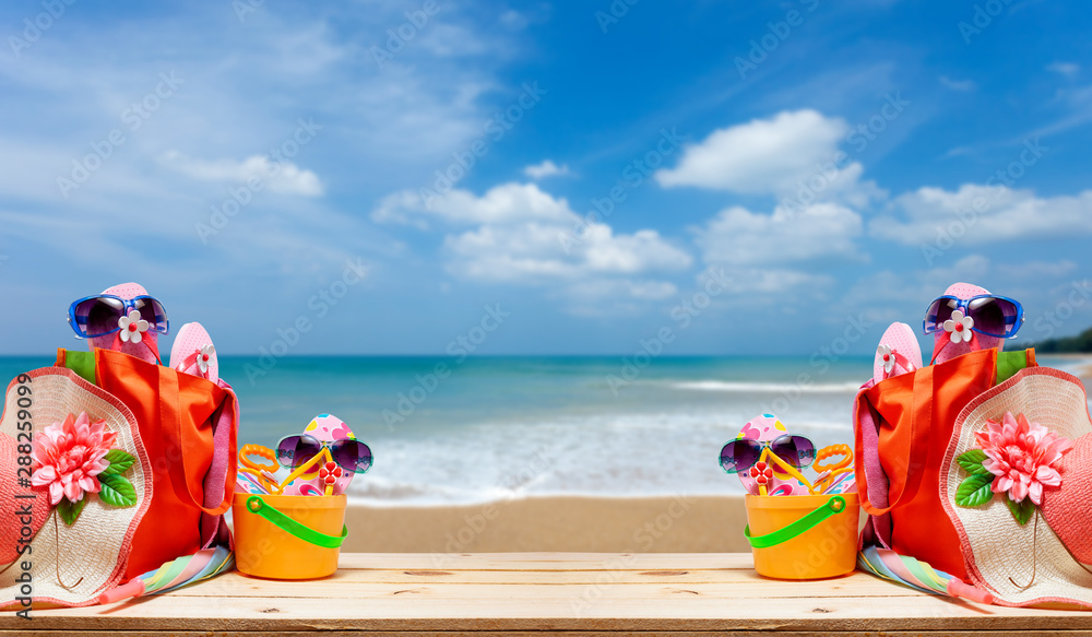 Obraz premium Beach accessory,hat,sunglasses,shoes,umbrella on wooden Beautiful beach background concept summer holiday background and summer sale