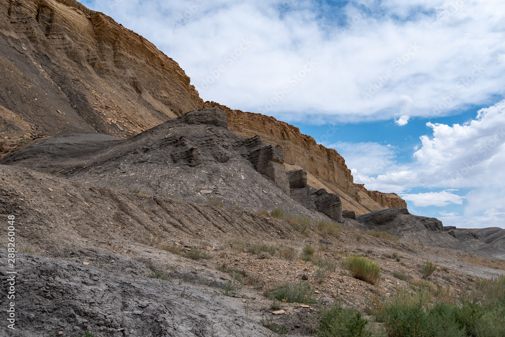 Stark landscape of grey and yellow rock formations or hills near Hanksville, Utah Stark landscape of grey and yellow rock formations or hills near Hanksville, Utah