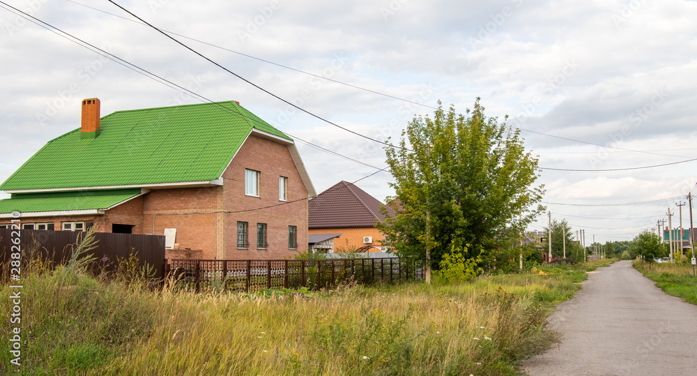 Brick house in village landscape nature summer day. Brick house in village landscape nature summer day.