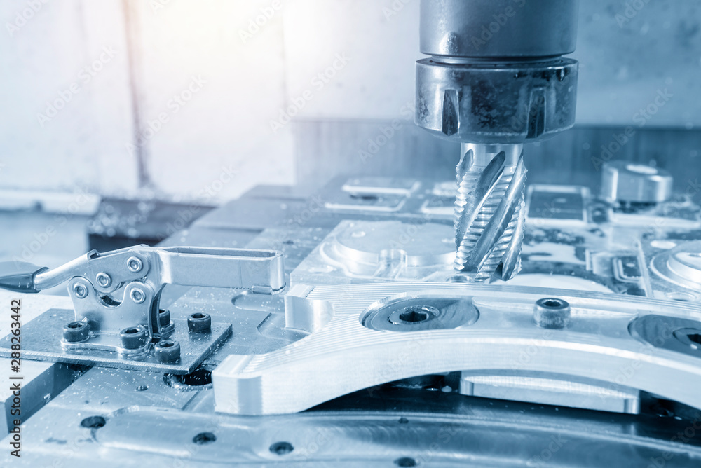 The machining center rough cutting the aluminium automotive parts with solid flat endmill tool in the light blue scene. The automotive parts cutting production processing by CNC milling machine. The machining center rough cutting the aluminium automotive parts with solid flat endmill tool in the light blue scene. The automotive parts cutting production processing by CNC milling machine.