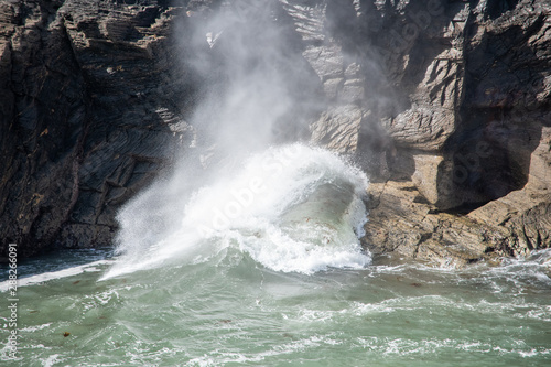 Large waves blowing through a hole in rocks in Boscastle