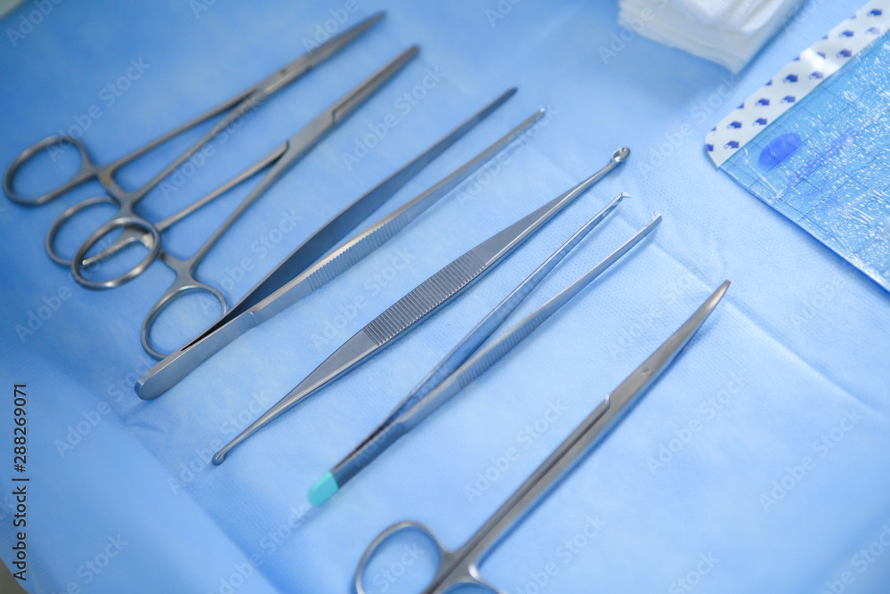Fototapeta premium Details with surgical stainless steel grasping instruments (artery and tissue forceps, spatula, hemostats)