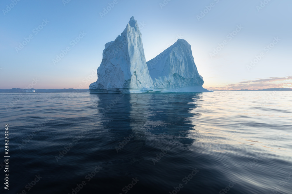 Icebergs in front of the fishing town Ilulissat in Greenland. Nature and landscapes of Greenland. Travel on the vessel among ices. Phenomenon of global warming. Ices of unusual forms and colors. Icebergs in front of the fishing town Ilulissat in Greenland. Nature and landscapes of Greenland. Travel on the vessel among ices. Phenomenon of global warming. Ices of unusual forms and colors.