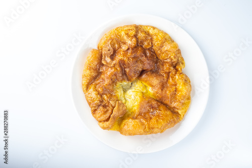 Top view traditional thai style omelet in ceramic plate on white background and copy space.