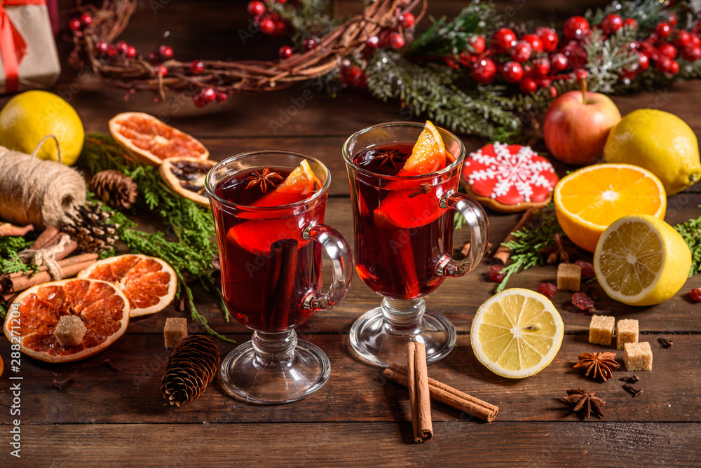 Christmas hot mulled wine with cinnamon cardamom and anise on wooden background