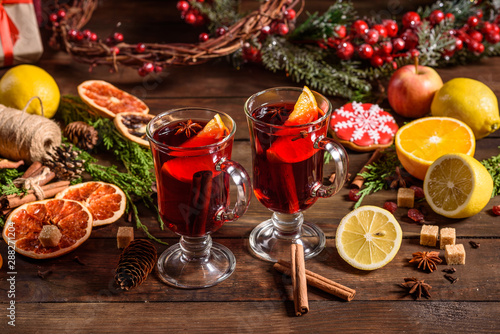 Christmas hot mulled wine with cinnamon cardamom and anise on wooden background © chernikovatv