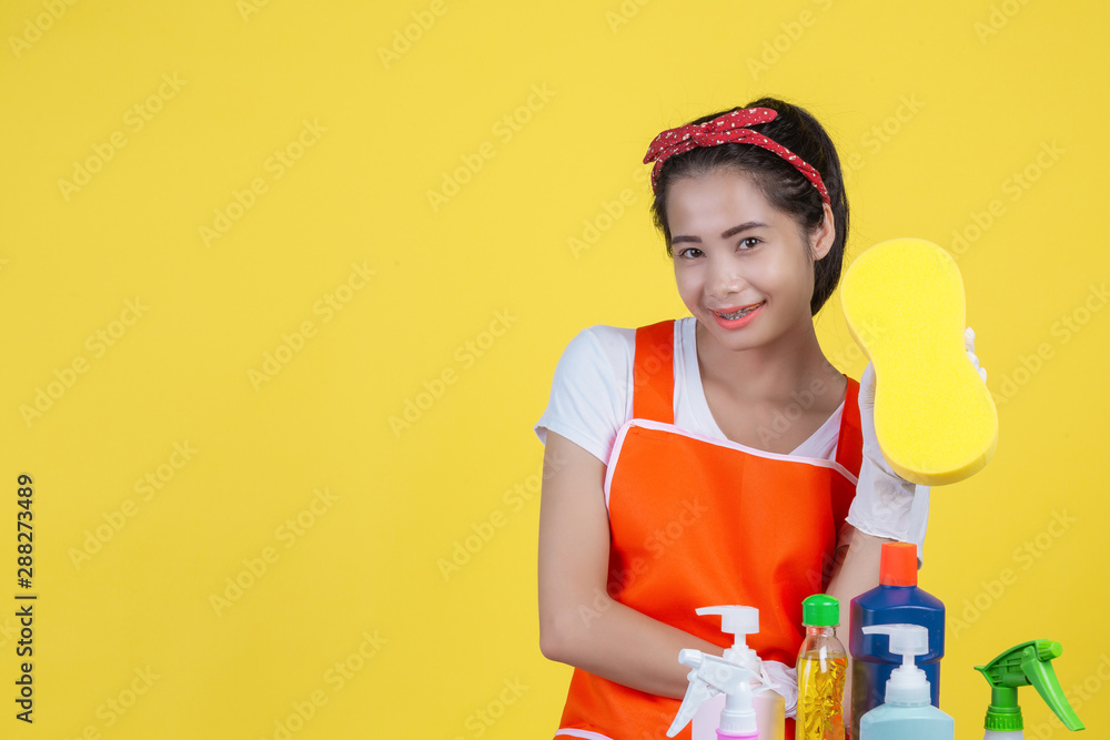 Cleaning concept. A beautiful woman with a cleaning device on a yellow background. Cleaning concept. A beautiful woman with a cleaning device on a yellow background.