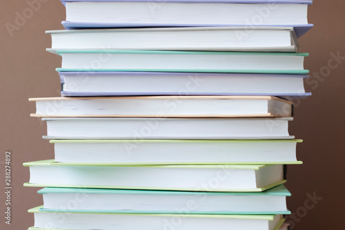 Stack of colorful books on brown background . Education background. Back to school.