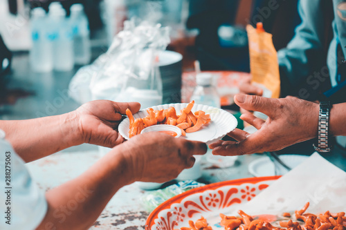 Charity food, Food for the poor hungry volunteers offering food to help the homeless : the idea of getting help from fellow humans