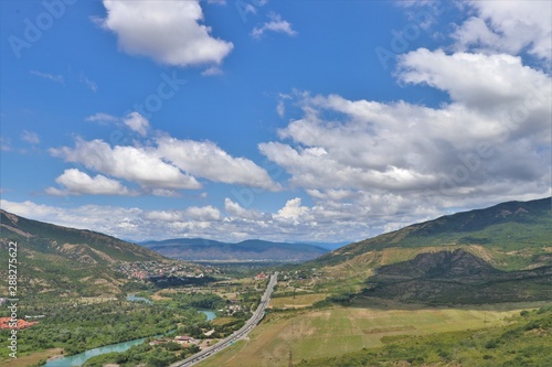 Aerial panoramic view of Mtskheta village, near Tbilisi, where the Aragvi river flows into the Kura river. View from the Jvary monastery hill. The Mtskheta village is part of the UNESCO heritage site.