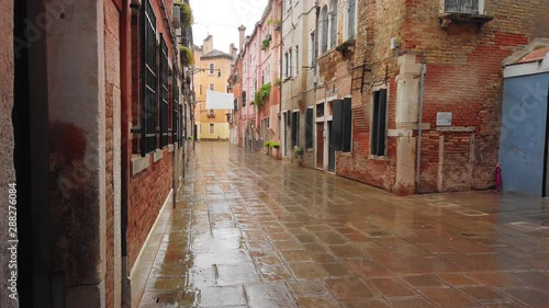 VENICE, Italy - May 2019: traditional street in Italy. Wet asphalt after rain. Slow motion.