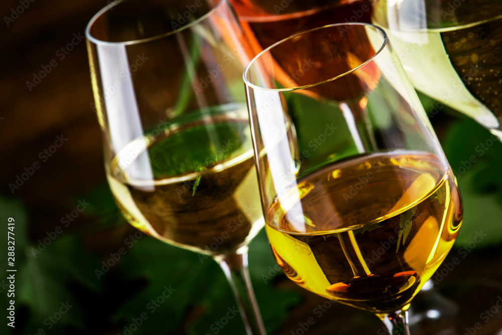 White wine set. Wine tasting, the most popular varieties of white wines in wine glasses on vintage wooden table in rustic style, selective focus - obrazy, fototapety, plakaty 