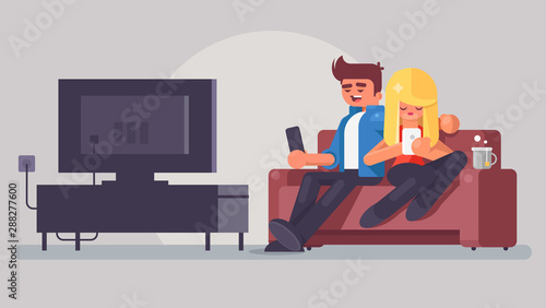 Young couple watching TV. Man and woman sit on against the TV in the home atmosphere. Vector illustration in a flat style