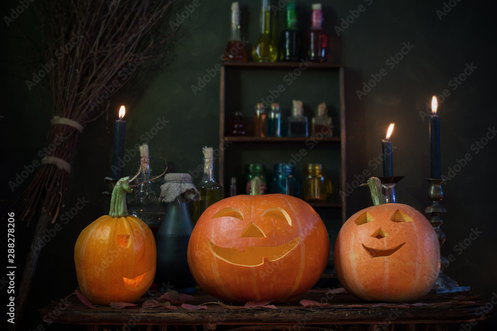 Obraz premium Halloween decoration with pumpkins and magic potions indoor