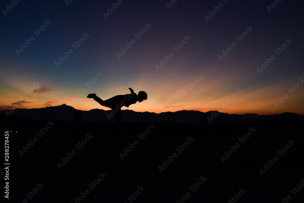 Silhouette of man doing at sunset, Concept lifestyle freedom vacation travel.