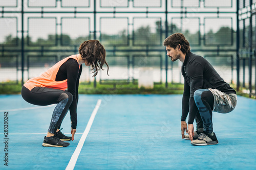 Young Female Athlete Exercising with Personal Fitness Trainer