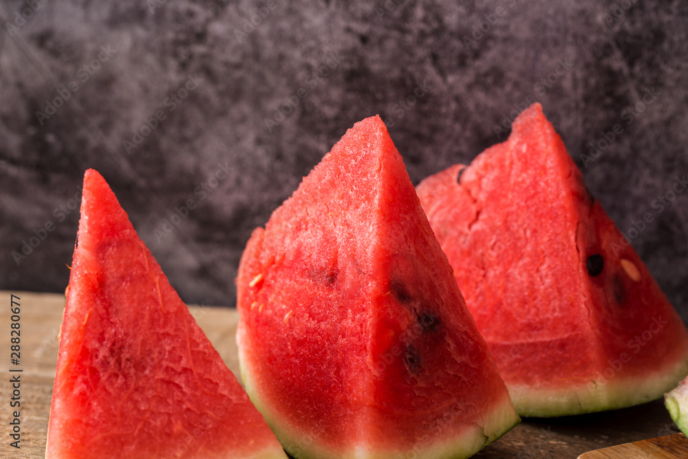 Slices of watermelon on wooden table Slices of watermelon on wooden table