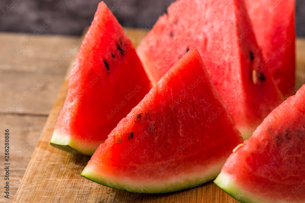 Slices of watermelon on wooden table Slices of watermelon on wooden table