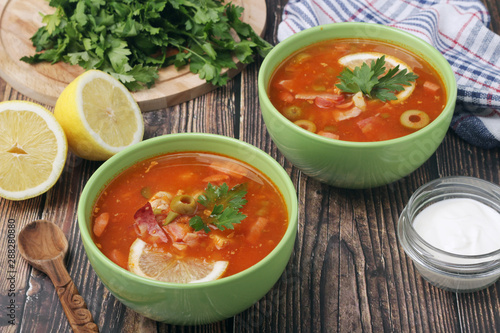 Two bowls with traditional Russian soup solyanka