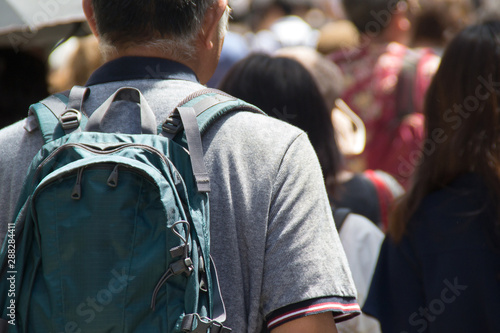 観光客　the aged with backpack in walking street