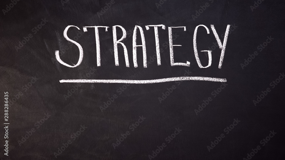 Fototapeta premium Strategy word written on blackboard, developing business, planning startup