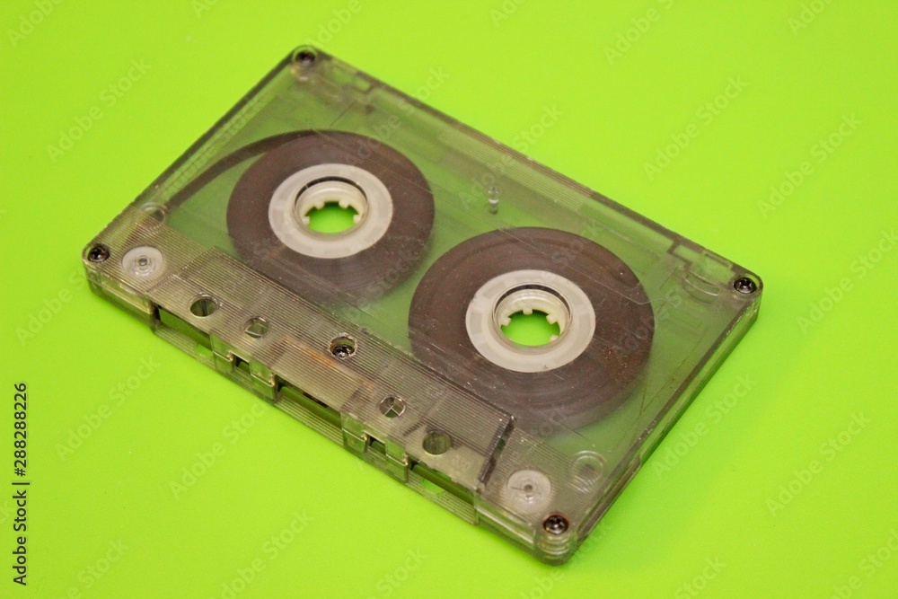 Old audio cassettes located on a green background Old audio cassettes located on a green background