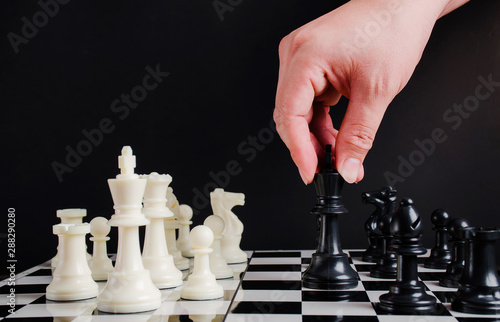 Hand of businessman moving chess board game in competition and development analysis for win and successful.