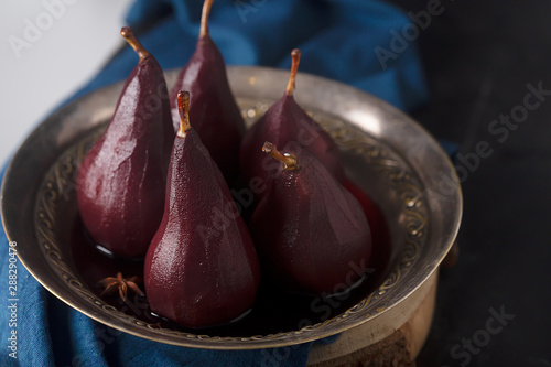 Poached pears in red mulled wine with cinnamon and anise