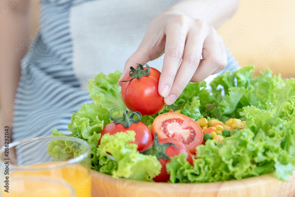 Close up shot of woman preparing salad or healthy meal in kitchen. Close up shot of woman preparing salad or healthy meal in kitchen.