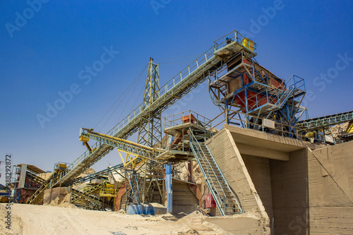 not working industrial digging factory heavy equipment in desert wasteland environment on blue sky background 