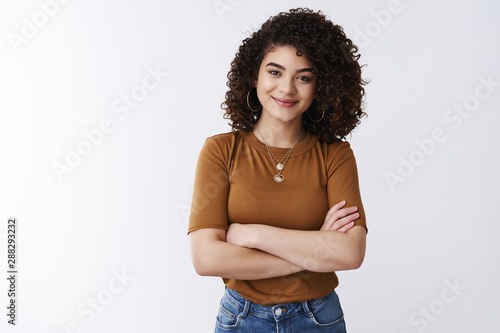 Girl not scared challenging tasks. Successful happy confident good-looking curly-haired customer service manager woman cross arms chest smile assertive self-assured feel empowered relaxed