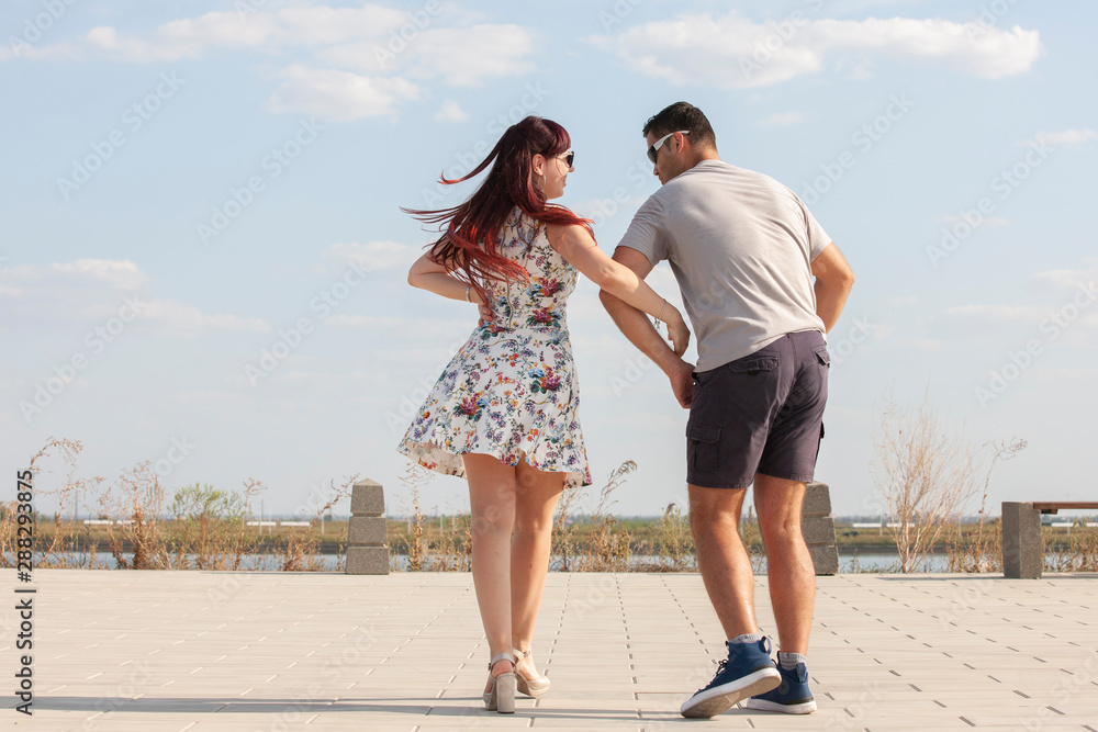 Passionate elegant young couple latino dancers in tango in the park, romantic and sporty lifestyle Passionate elegant young couple latino dancers in tango in the park, romantic and sporty lifestyle