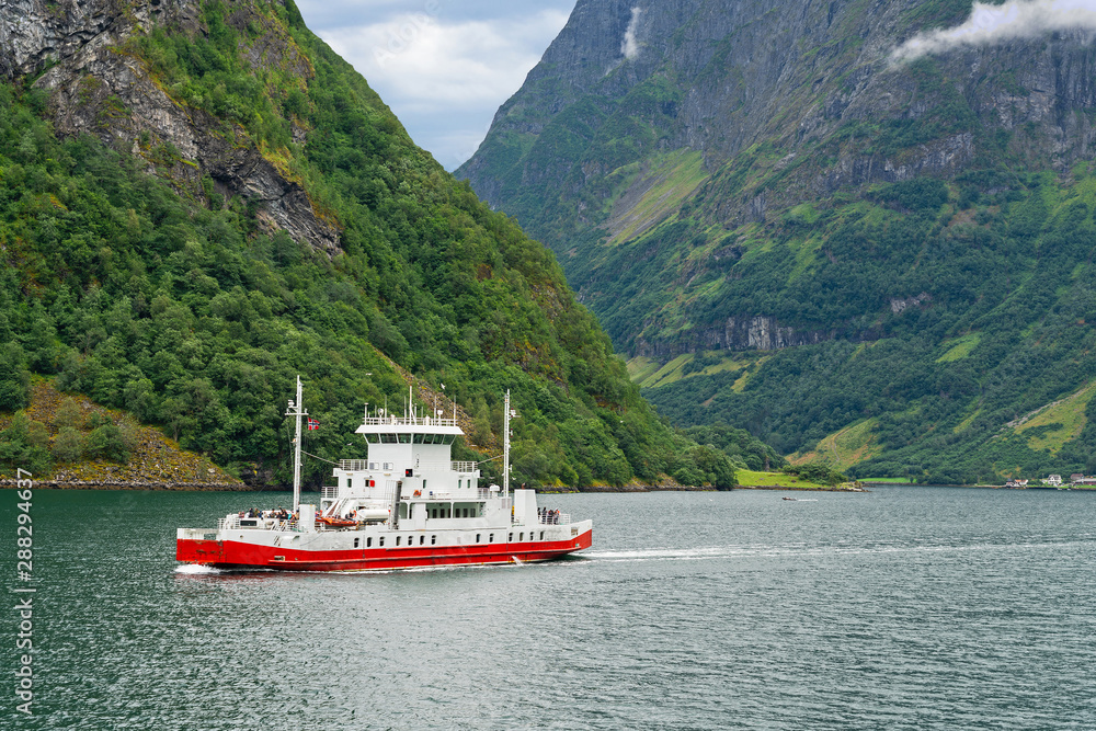 Ferry ship sailing in Sognefjord mountains, Norway