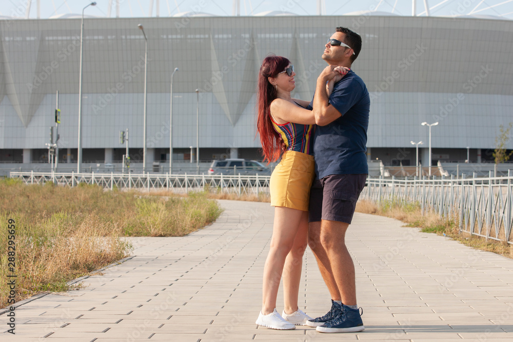 Couple dancing at sunset salsa brazilian zouk. Lovers, dance partners spinning, latin festival dance concept.