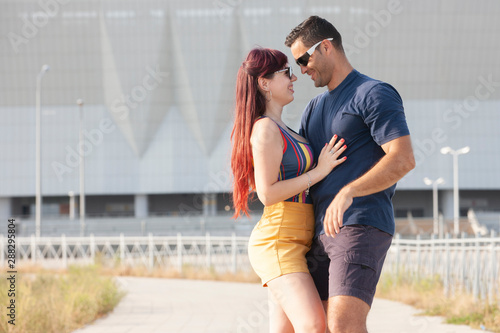 Couple dancing at sunset salsa brazilian zouk. Lovers, dance partners spinning, latin festival dance concept.