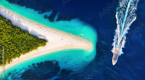 Fototapeta Naklejka Na Ścianę i Meble -  Croatia, Hvar island, Bol. Aerial view at the Zlatni Rat. Aerial view of luxury floating boat on blue Adriatic sea at sunny day. Travel - image