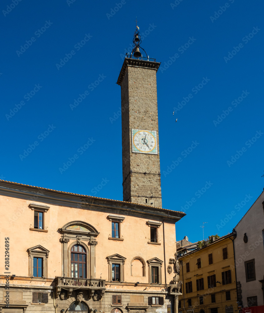 Fototapeta premium Ancient stone clock tower in the public square in the old town of Viterbo, Italy