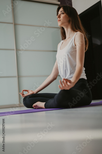 Young slender girl doing yoga