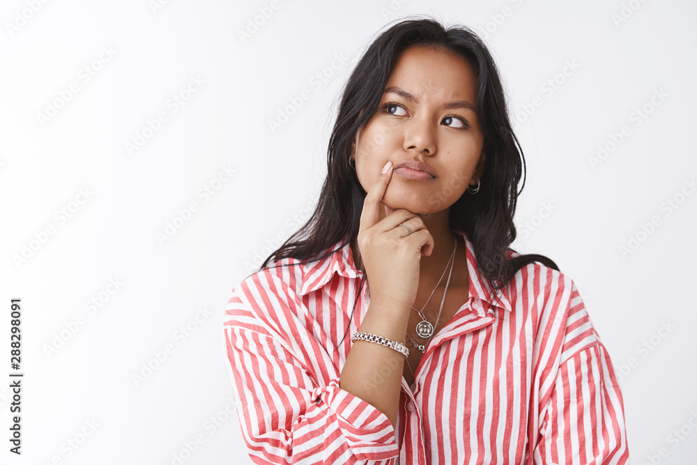 Close-up shot of thoughtful focused woman having tough problematic thought making decision in mind frowning touching lip and looking at upper left corner, thinking against white background Close-up shot of thoughtful focused woman having tough problematic thought making decision in mind frowning touching lip and looking at upper left corner, thinking against white background