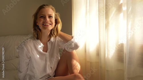 Beautiful Model with Her Thoughts Wandering by the Bed Near the Windowsill