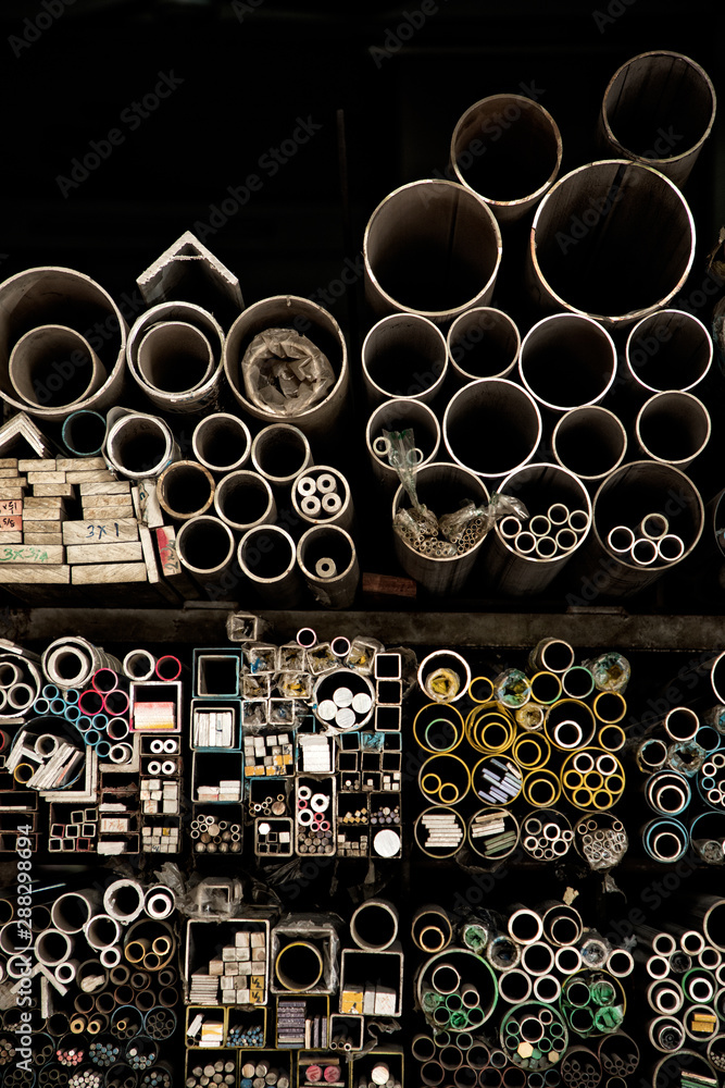 Close up various shape industrial steel products of metal profiles and tubes on warehouse shelf Close up various shape industrial steel products of metal profiles and tubes on warehouse shelf