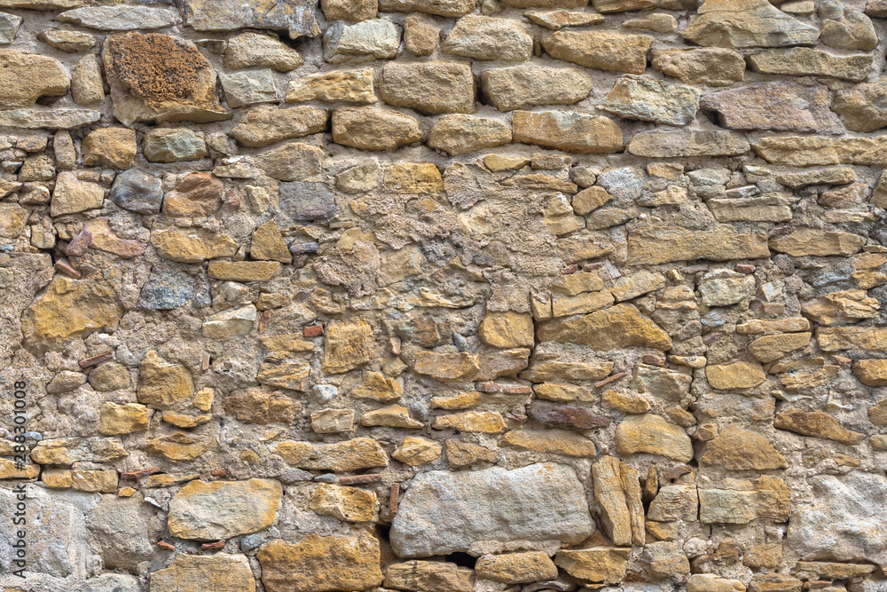 Aged yellow bricks and stones wall. Brick background Aged yellow bricks and stones wall. Brick background