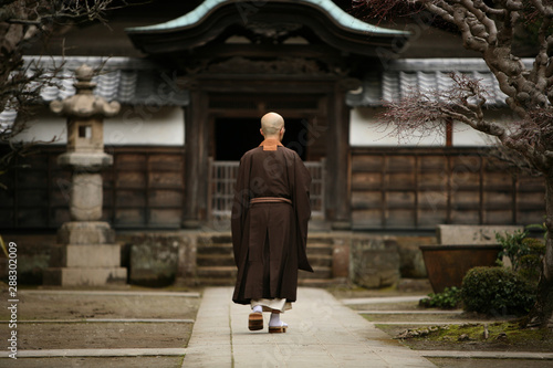A monk in court yard of a monastery in Kamakura, Japan.