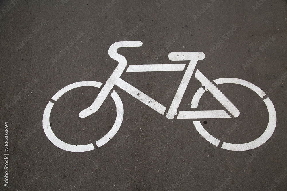 Pictogram with the image of a white Bicycle on gray asphalt. Traffic safety. Pictogram with the image of a white Bicycle on gray asphalt. Traffic safety.
