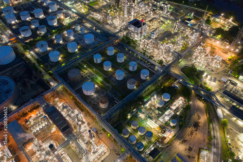 Aerial view of petrochemical oil refinery and sea in industrial engineering concept in Bangna district at night, Bangkok City, Thailand. Oil and gas tanks pipelines in industry. Modern metal factory. photo