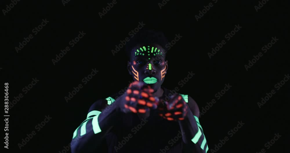 Studio, slow motion, close-up of a neon-painter dancing Studio, slow motion, close-up of a neon-painter dancing