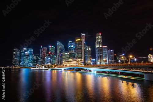 Business building and Merlion park and marina bay sand illuminated,landmark architecture at night in Singapore.