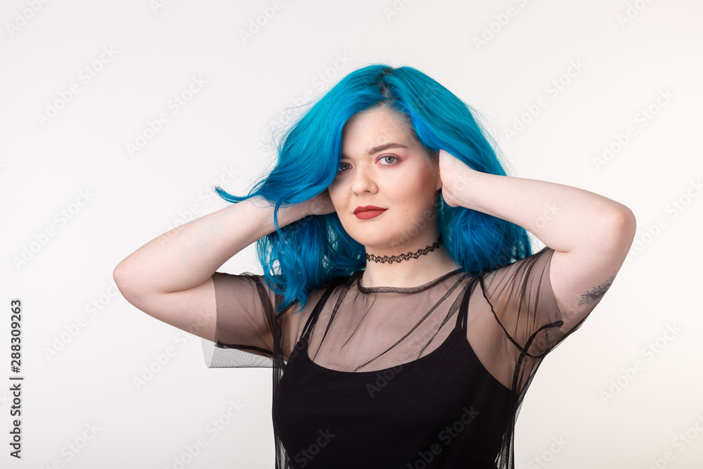 People and fashion concept - Beautiful woman with blue hair posing over white background