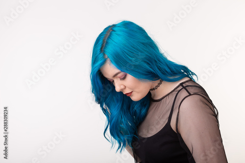 People and fashion concept - Beautiful woman with blue hair posing over white background