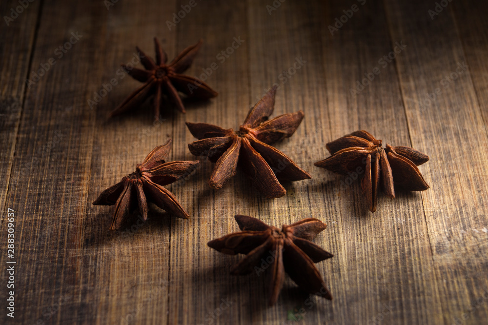STAR ANISE ON WOODEN BACKGROUND, MACRO PHOTOGRAPHY OF GARAM MASALA ON WOODEN TEXTURE BACKGROUND, 
